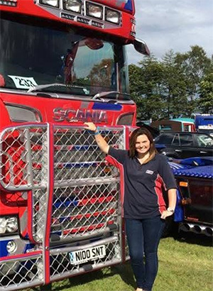 Claire in front of a red truck