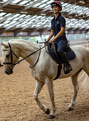 Female veterinary surgeon riding a horse